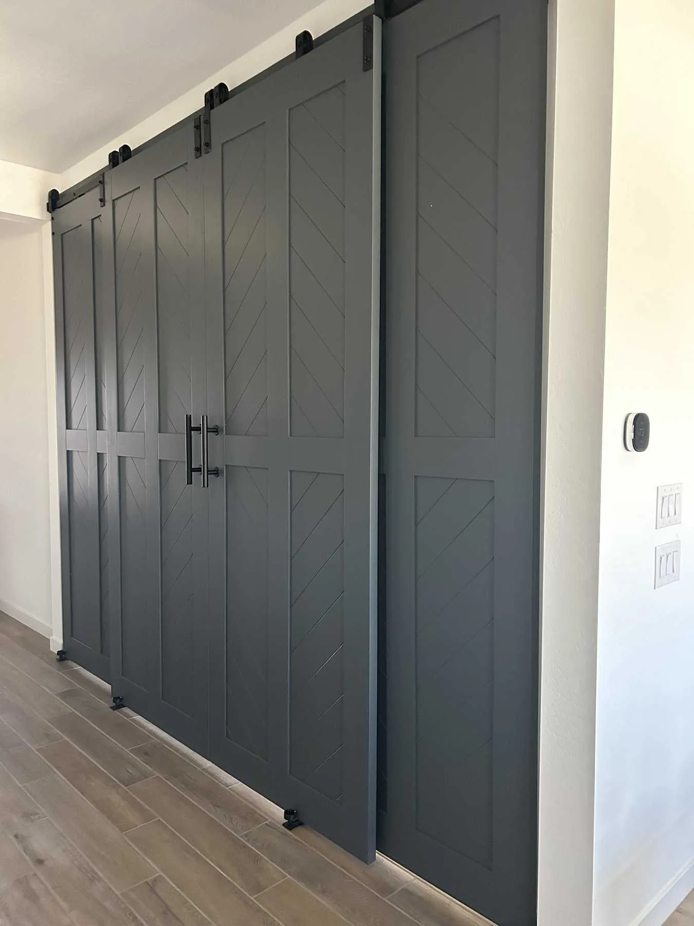 Four Door Bypass Diagonal Plank barn doors, closed across a wide opening