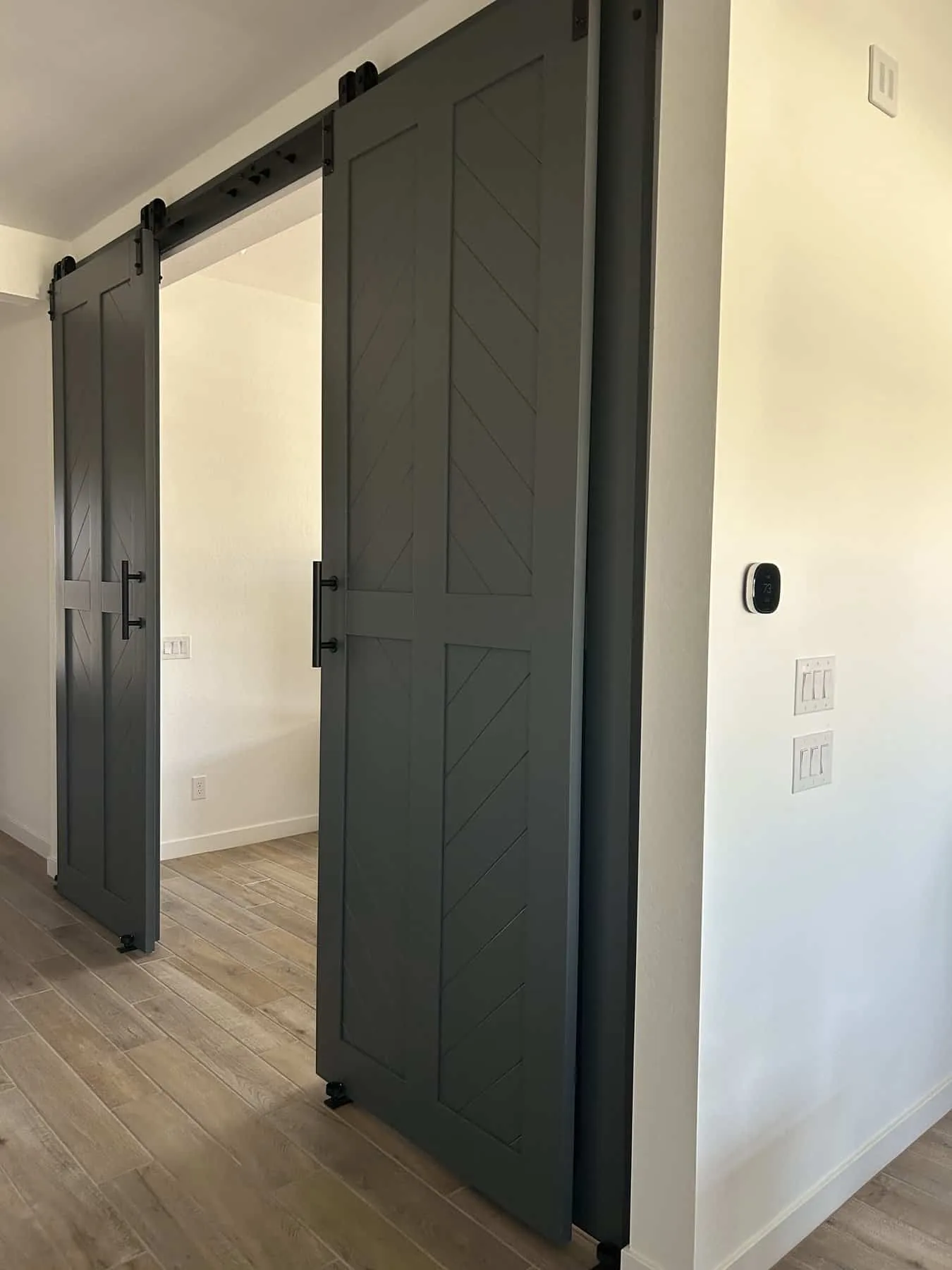 Four Door Bypass Diagonal Plank barn doors, slid open on a stacked track