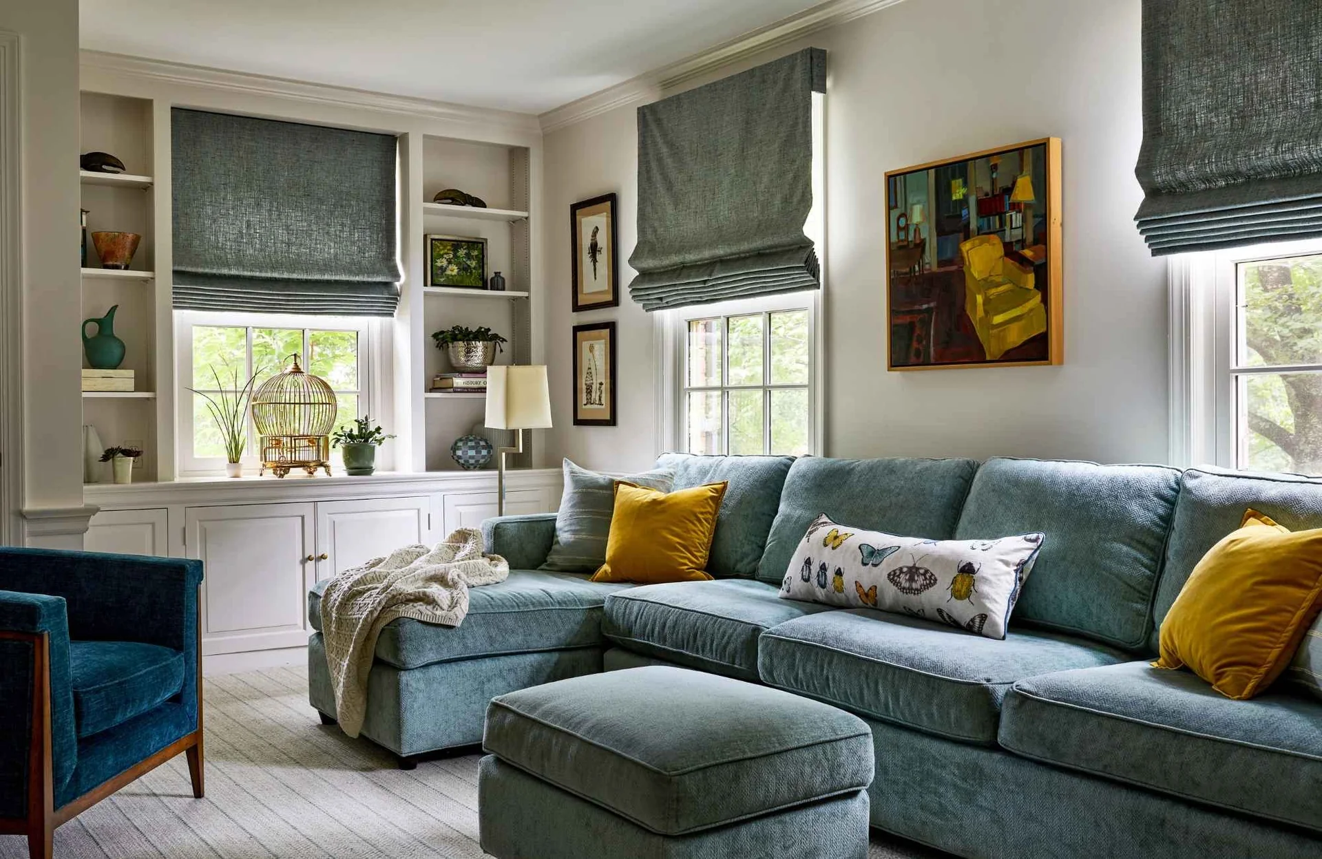 Grey roman shades in a family room
