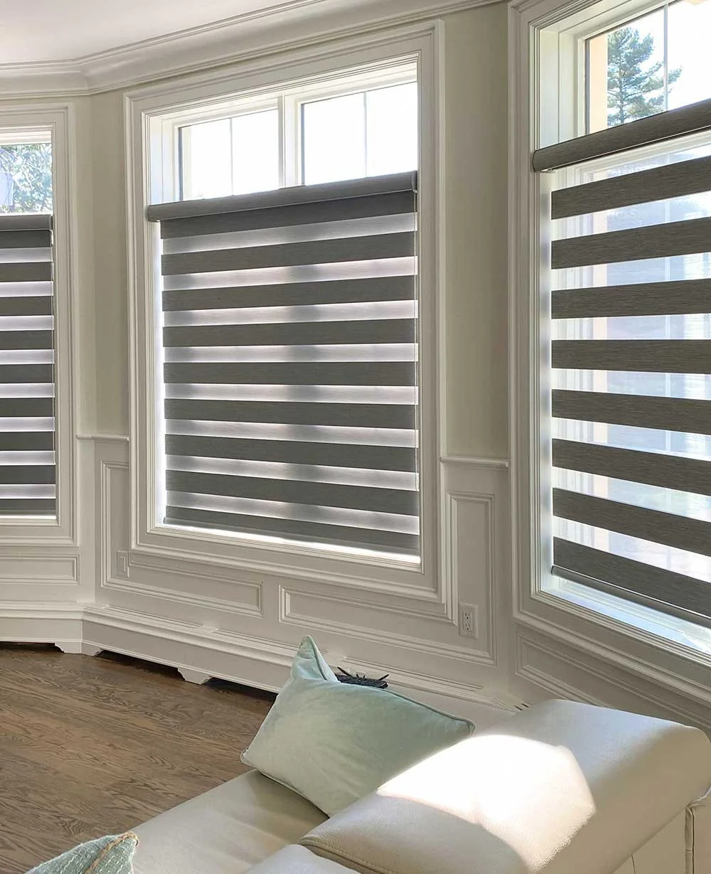 Grey zebra shades on a bay window