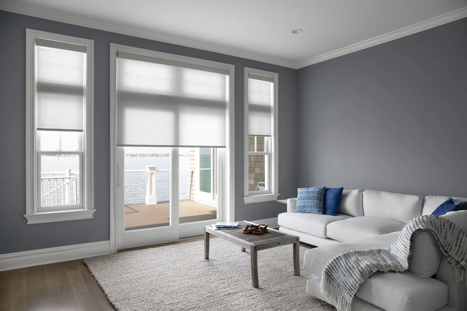 Grey light-filtering roller shades in a living room