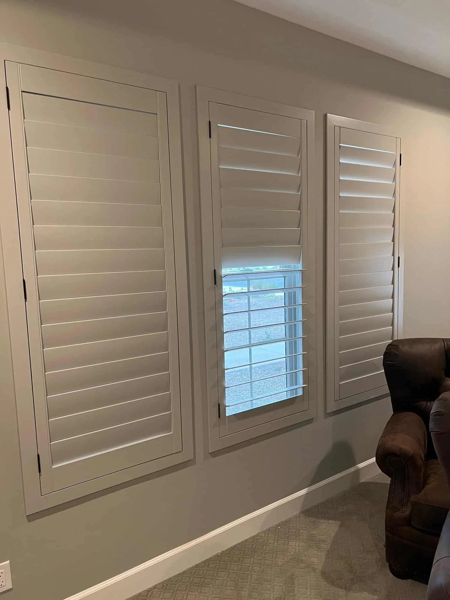 Angled view showing shutter panel depth against wainscoting