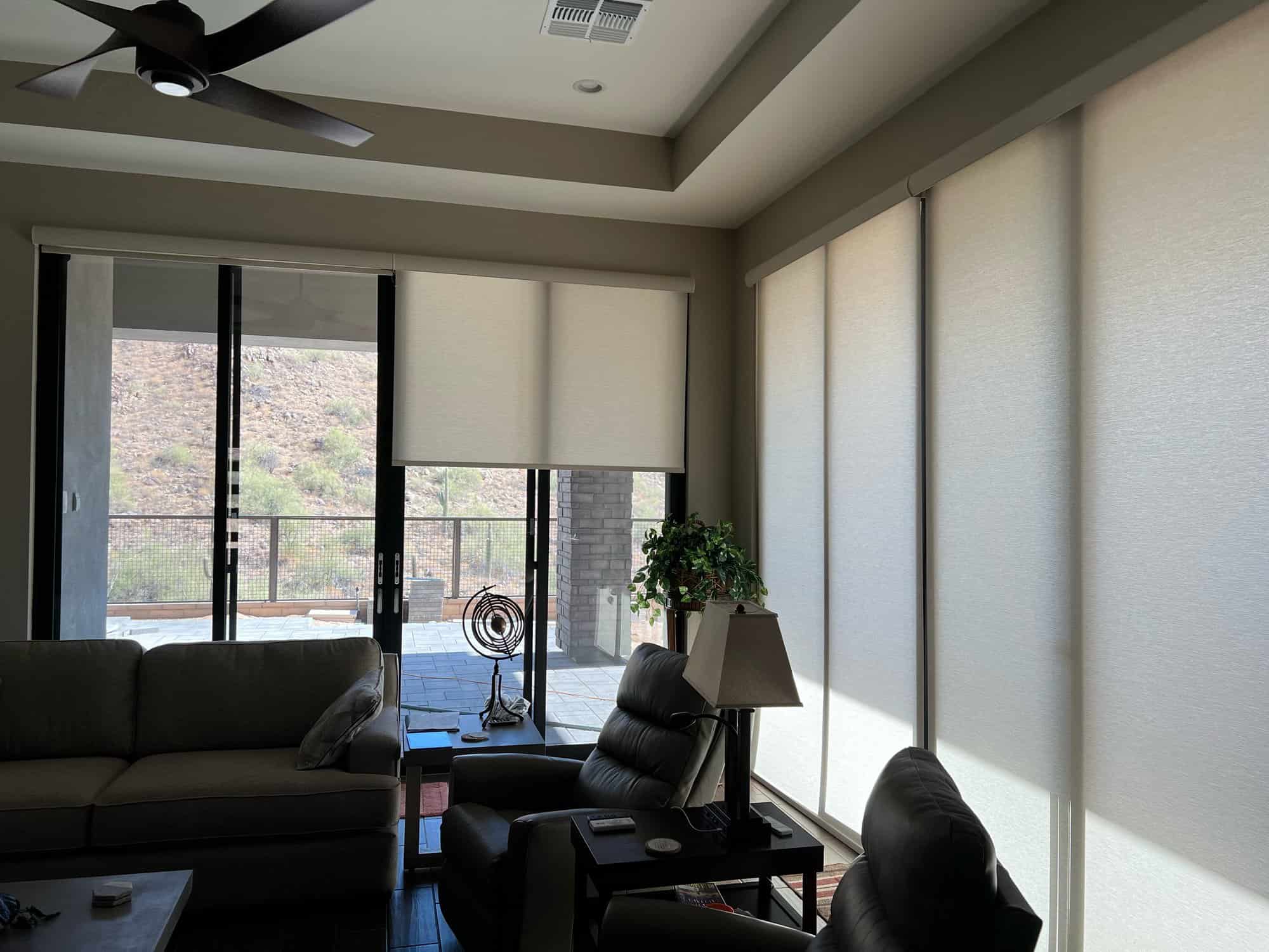 Roller shades framing a desert view living room