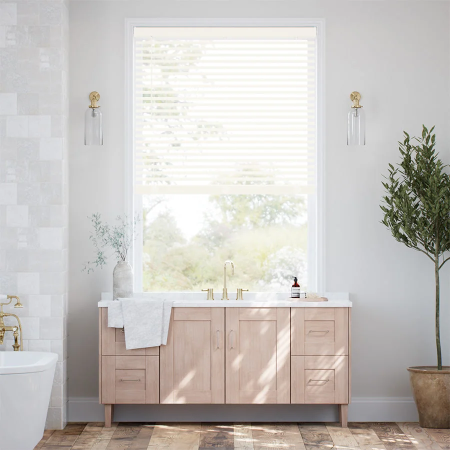 White faux wood blinds above a bathroom vanity
