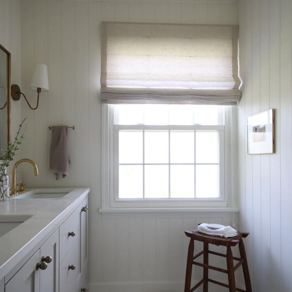 White flat roman shade on a bathroom window